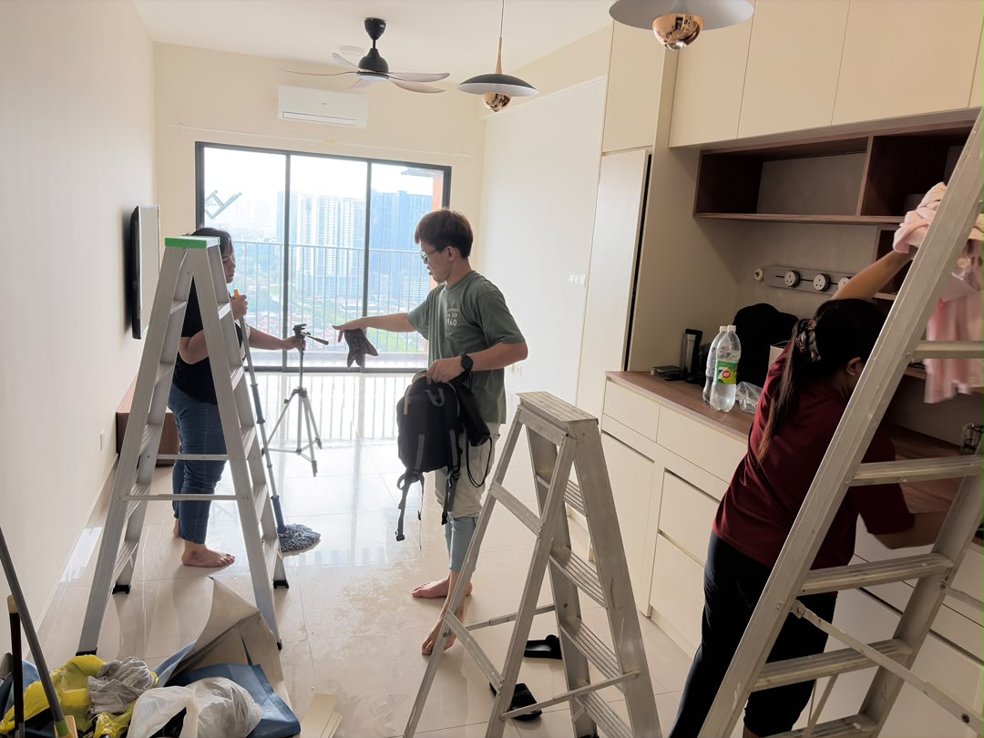 ServiceKru crew on ladders cleaning a living room and cabinets