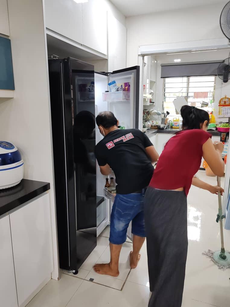 ServiceKru crew cleaning a kitchen and refrigerator