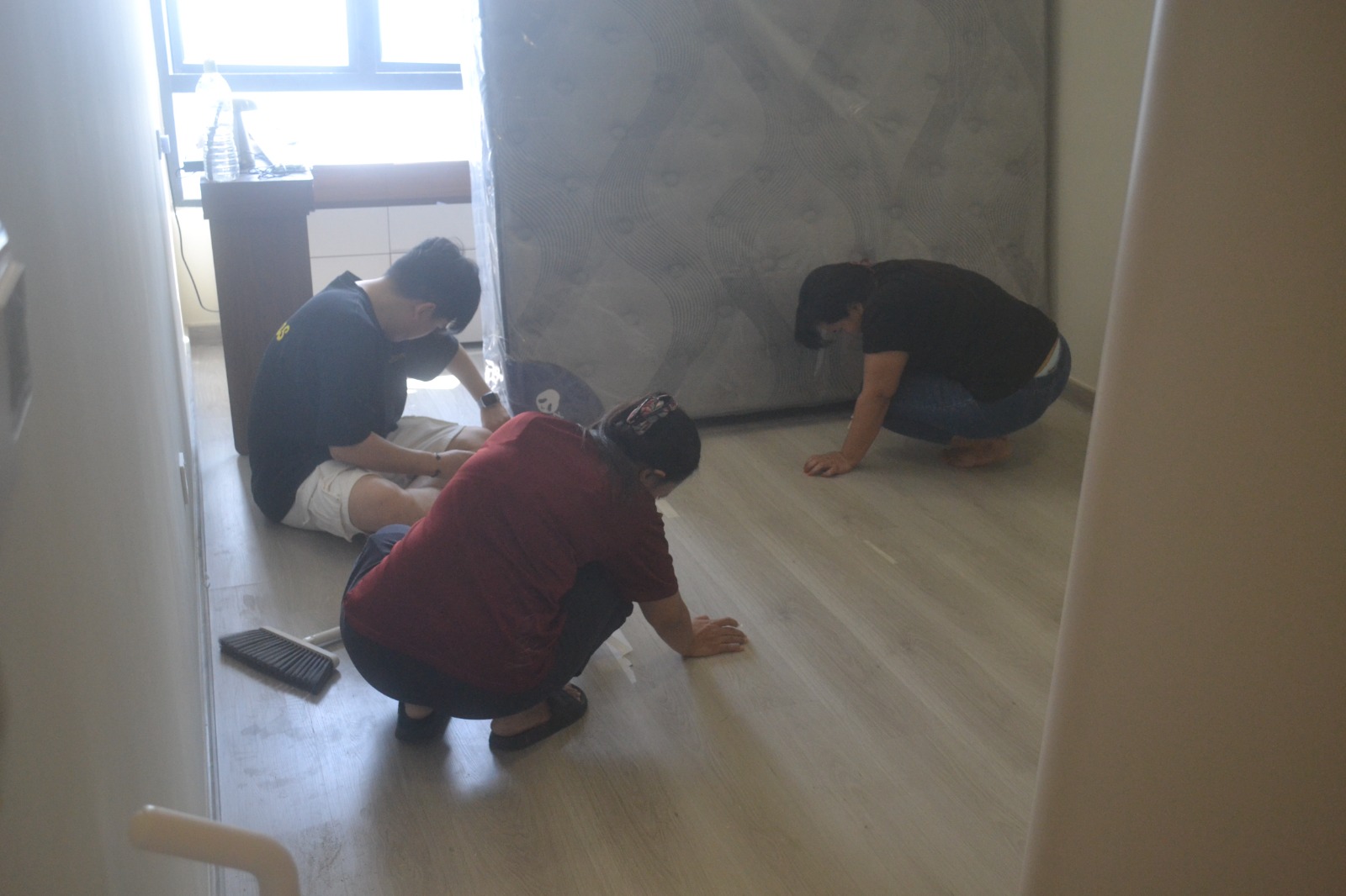 ServiceKru crew unwrapping a new mattress during move-in prep