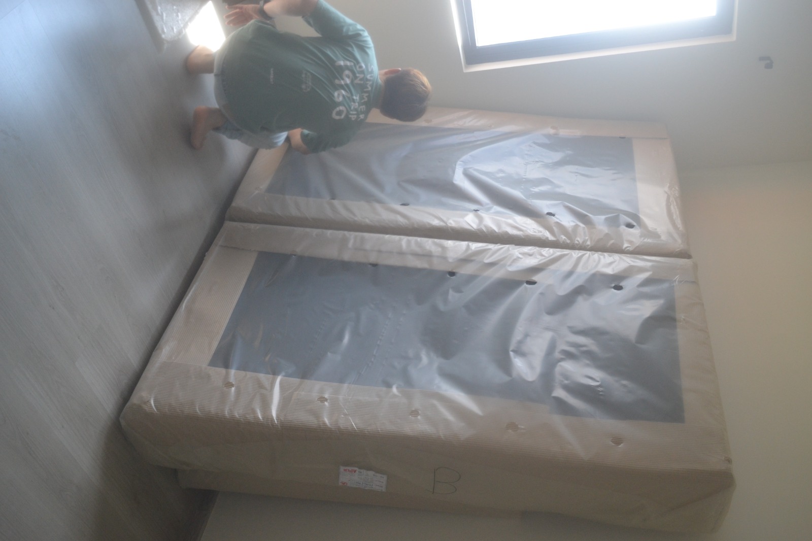 ServiceKru crew cleaning the floor beside a new mattress